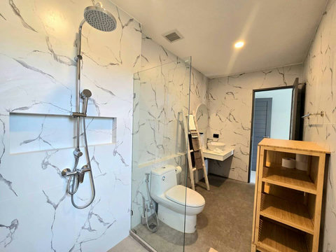 Natural stone bathroom with shower and warm wood accents