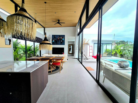 Spacious living room with entertainment area and high ceiling