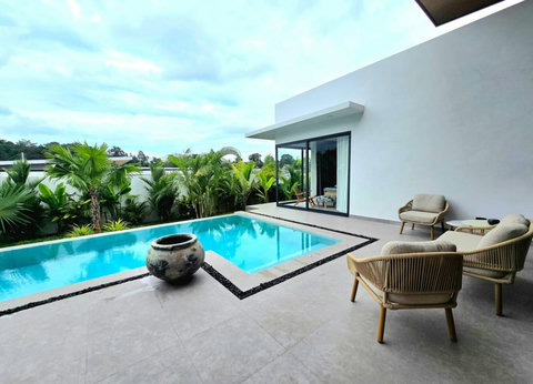 Tropical garden with covered sala and swimming pool