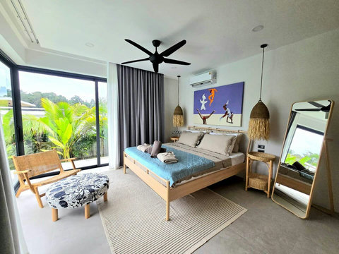 Bright tropical bedroom with wicker furniture and ocean-blue walls