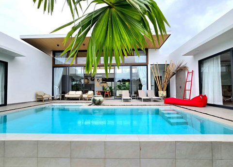 Elegant indoor living space with traditional decor and pool access