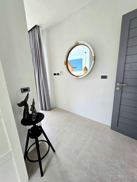 Clean bathroom entrance with contemporary basin and mirror