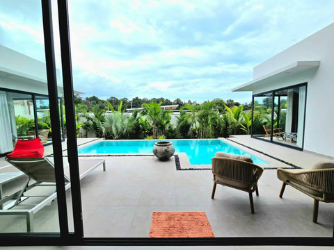 Sparkling pool with sun deck and contemporary villa design