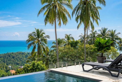 Hillside pool and tropical garden with stunning ocean views at Sunrise Hill Villa Thailand