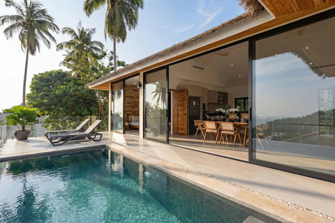 Evening ambiance at Sunrise Hill Villa pool with illuminated terraces and hillside gardens, Koh Samui