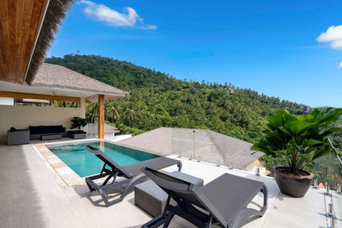 Elevated pool terrace with sun loungers and modern architecture at Sunrise Hill Villa Thailand