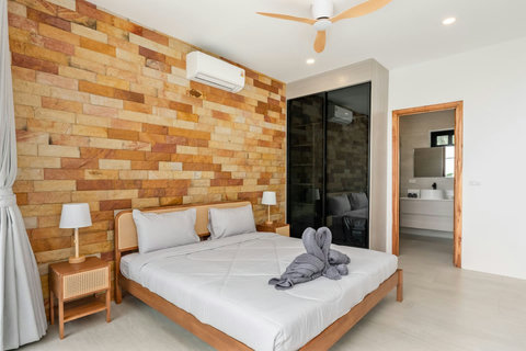 Comfortable bedroom with modern tropical design and towel art at Sunrise Hill Villa Thailand