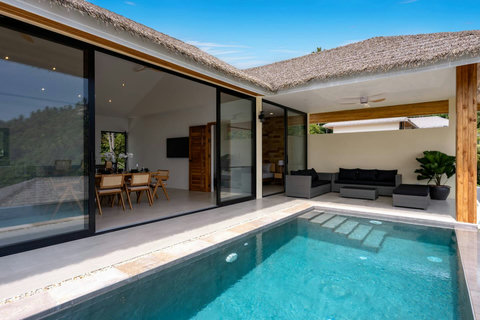 Modern poolside retreat with contemporary design and sun loungers at Koh Samui hillside villa