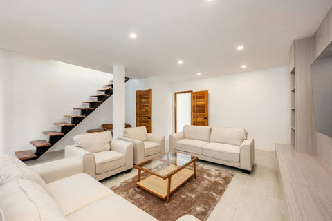 Light-filled family lounge with comfortable seating and modern interior, Koh Samui vacation rental