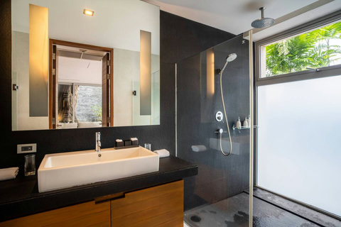 Luxury ensuite bathroom with freestanding tub overlooking the sea at Laemsingh Villa, Phuket