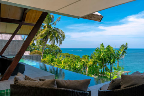 Tropical garden pathway with lush greenery and stunning ocean views at Laemsingh Villa, Phuket