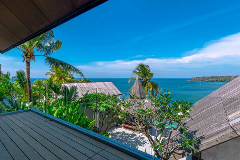 Crystal-clear turquoise waters and palm-fringed beach near Laemsingh Villa, Surin Beach Phuket