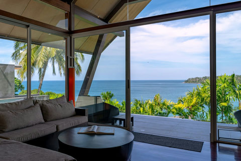 Covered terrace pavilion with glass balustrade and ocean views at Laemsingh Villa, Phuket