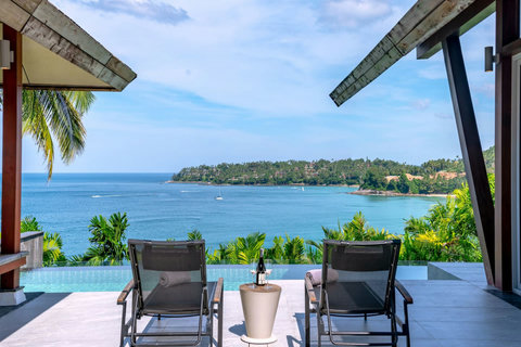 Tropical beachfront paradise with swaying palms and turquoise sea near Laemsingh Villa