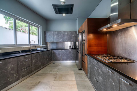 Fully equipped gourmet kitchen with premium dark stone finishes at Laemsingh Villa, Phuket