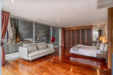 Bright contemporary bathroom with premium fixtures and natural light at Laemsingh Villa