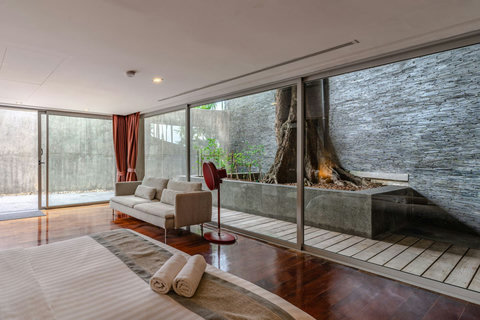 Natural stone feature with lush tropical plantings at Laemsingh Villa, Surin Beach Phuket