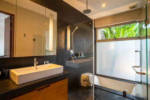 Sophisticated room with timber accents and ambient lighting at Laemsingh Villa, Phuket