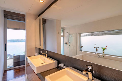 Modern double vanity bathroom with natural light at Laemsingh Villa, Surin Beach Phuket