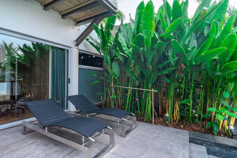Open-air tropical living space with garden views at Laemsingh Villa, Surin Beach Phuket