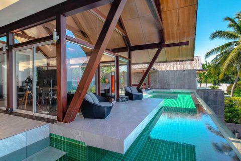 Illuminated night pool with covered timber pavilion at Laemsingh Villa, Surin Beach Phuket