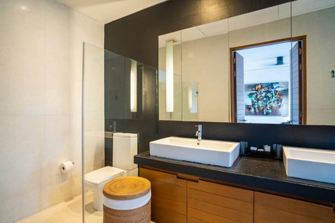 Designer bathroom with artisan vessel sink and modern vanity at Laemsingh Villa, Phuket