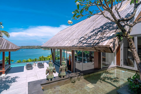 Traditional wooden sala with outdoor dining and garden setting at Laemsingh Villa, Phuket