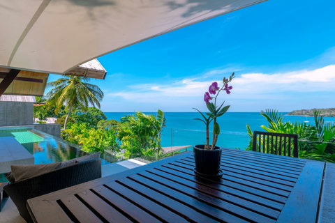 Lush tropical garden terrace with panoramic sea views at Laemsingh luxury villa, Phuket