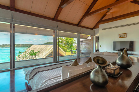 Elegant master bedroom with canopy bed and sweeping ocean views at Laemsingh Villa, Phuket