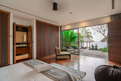 Tropical garden entrance with lush greenery and natural stone path at Laemsingh Villa