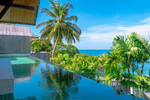 Tropical garden oasis with towering palms and Andaman Sea views at Laemsingh Villa