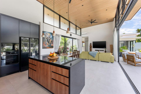 Fully equipped modern kitchen with sleek dark cabinetry at Villa Solunara, Koh Samui rental