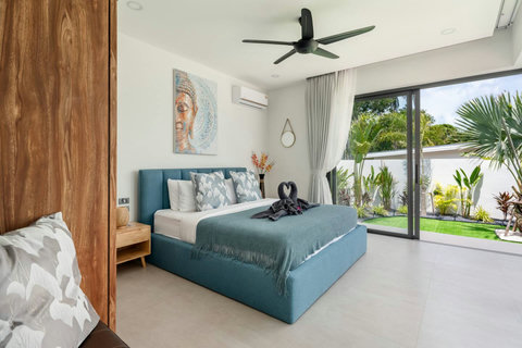 Spacious bedroom with ceiling fan and tropical decor at Villa Solunara, Koh Samui vacation rental
