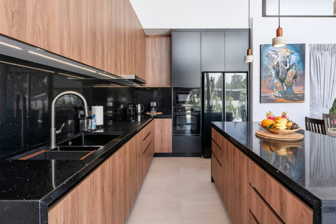 Gather for meals in this light-filled dining space that opens directly to the tropical gardens.