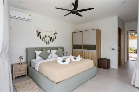 Elegant master bedroom with king bed and tropical touches at Villa Solunara, Koh Samui