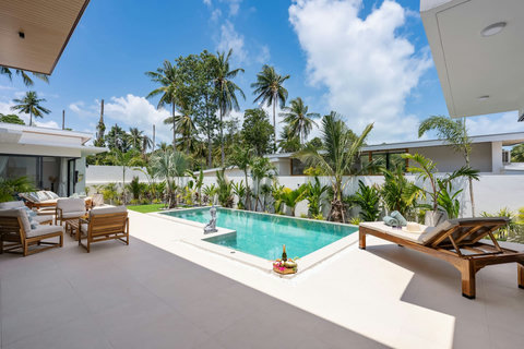 Poolside lounge area with outdoor seating at Villa Solunara, family-friendly rental in Koh Samui