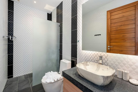 Modern bathroom with wooden vanity and vessel sink in this luxury Koh Samui vacation rental