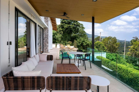 Open-air covered lounge with natural wood beams and sea views at Villa Ombra, Mae Nam