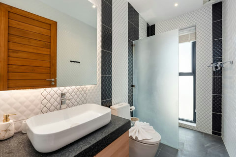 Stylish ensuite bathroom with freestanding bathtub and geometric tiles at Villa Ombra Koh Samui