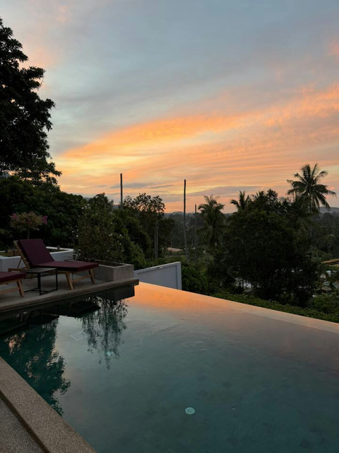 Spectacular tropical sunset with palm trees from the pool terrace at Villa Ombra, Koh Samui