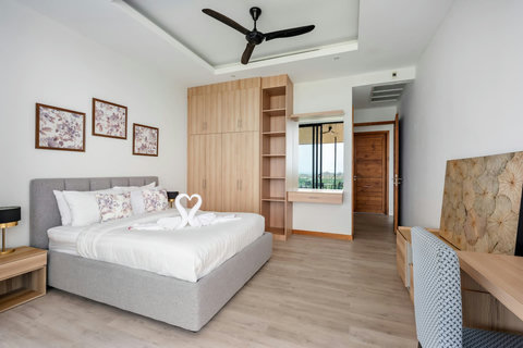 Comfortable twin bedroom with stylish wall decor, ideal for families at Villa Ombra Mae Nam