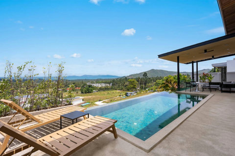 Aerial view of Villa Ombra pool deck and outdoor lounge area surrounded by tropical gardens