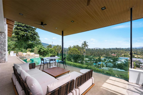 Cozy living room with warm wood tones and stylish furnishings at Villa Ombra Koh Samui