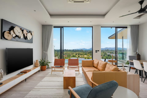 Poolside outdoor living area with panoramic mountain and sea views at Villa Ombra Thailand