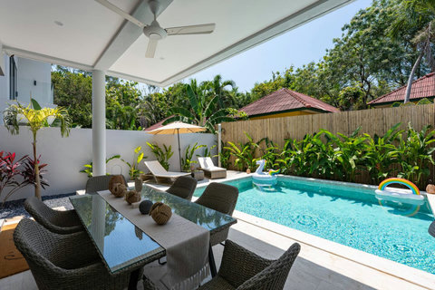 Your private villa entrance welcomes you with a clean, modern design and a inviting garden space.
