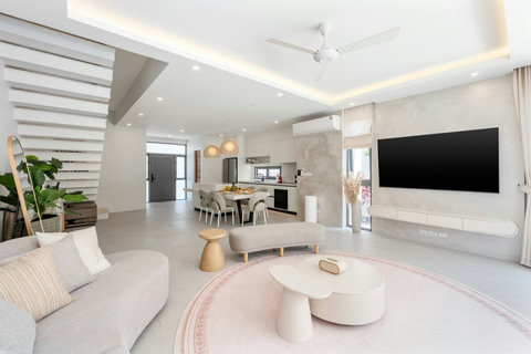 Gather in this bright, airy living space flowing seamlessly from lounge to kitchen. Natural light floods through skylights.