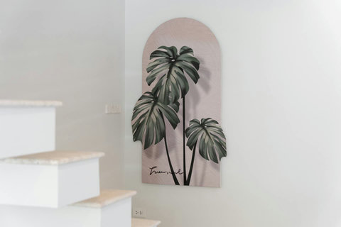 Thoughtful design details like this botanical wall art bring the calm tropical mood throughout the villa.