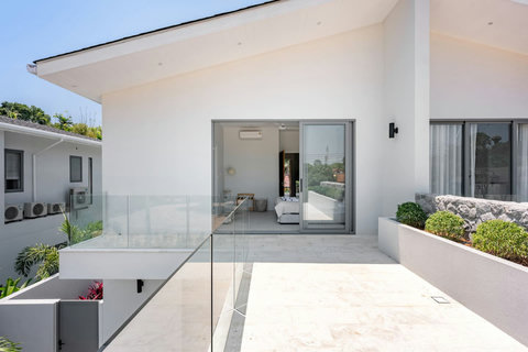 Step into a spa-like shower with overhead rainfall spray and marble-effect walls. Every wash feels like a small luxury.