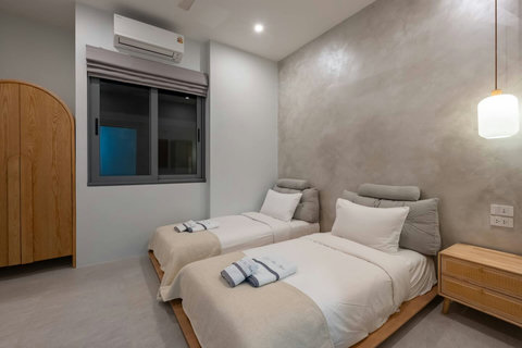 Comfortable bedroom with two beds and your own balcony access, cool air conditioning to keep you refreshed.