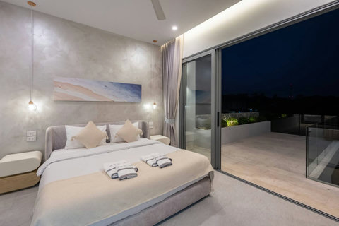 Sleep soundly in this serene bedroom, then step straight out to your private garden terrace through wide glass doors.